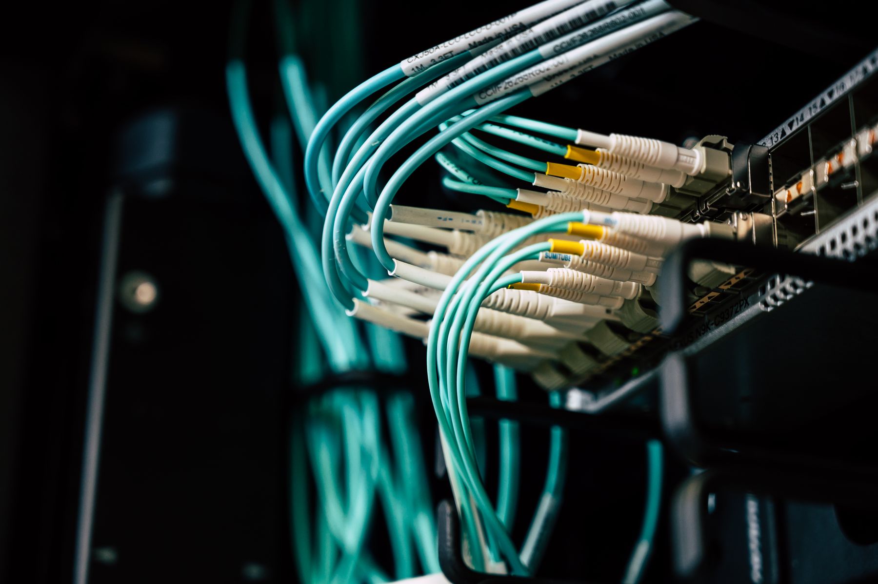 Fibre-optic cables connected to network equipment.