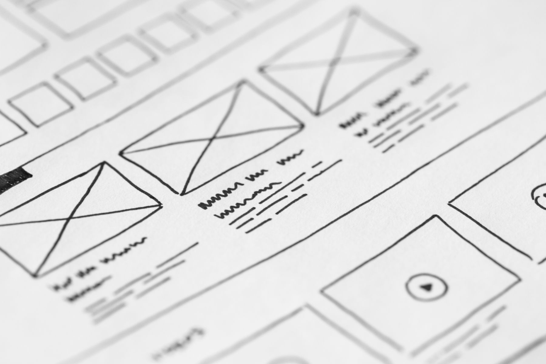 A close view of a hand-drawn website layout on paper.