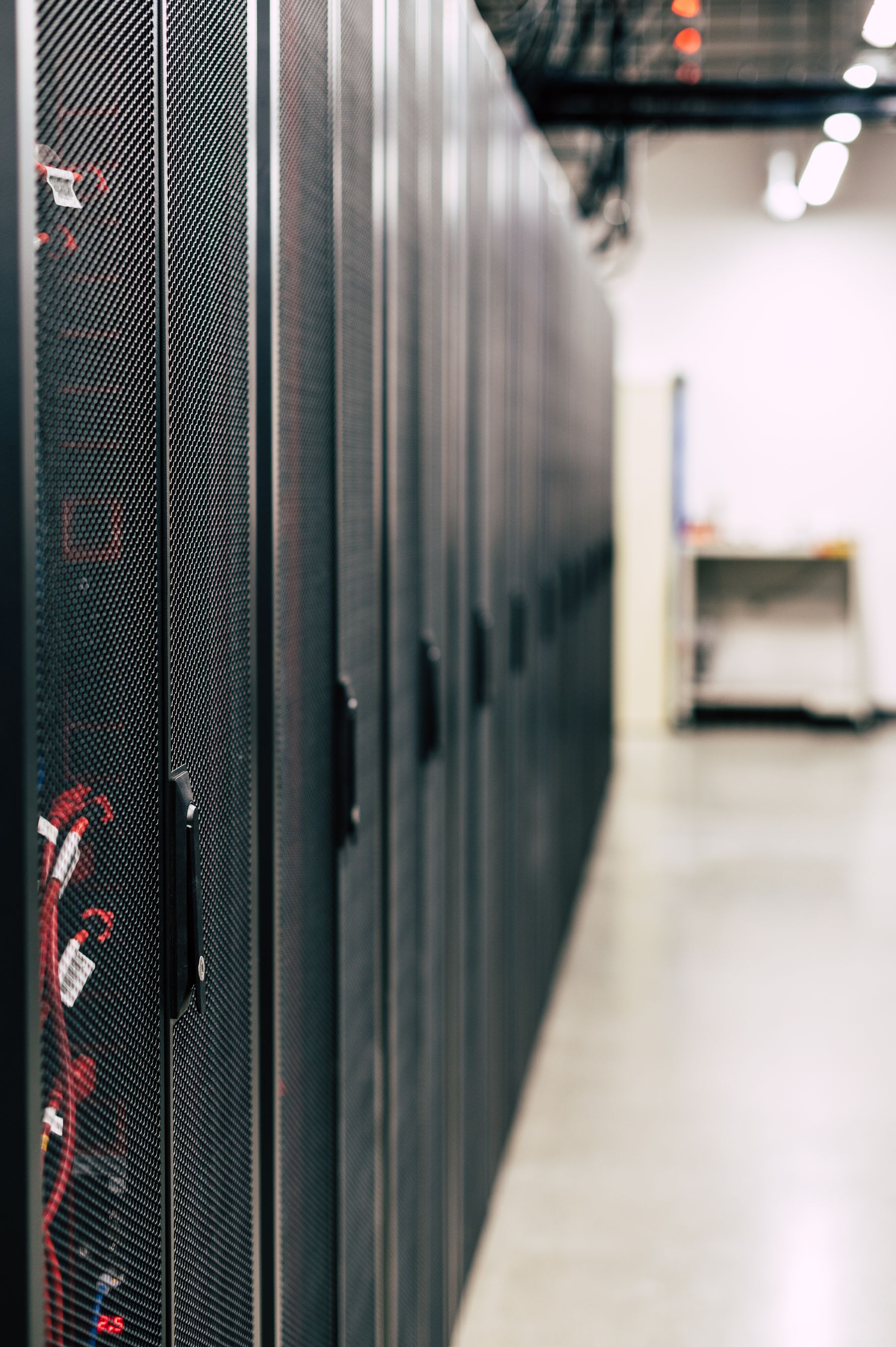 A close view along a row of server cabinets.