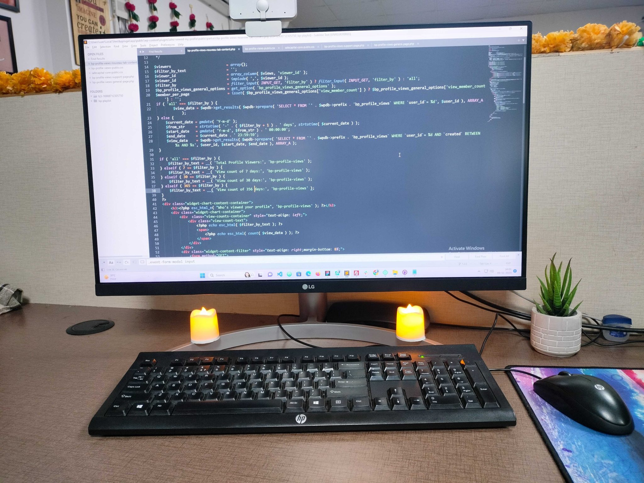 A monitor displaying WordPress plugin source code at a working desk.